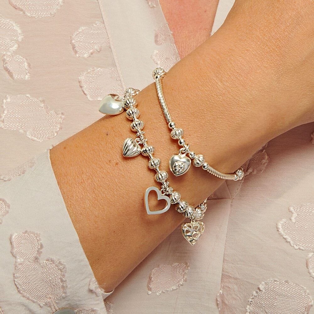 Lot - Two Sterling Silver Charm Bracelets with Predominantly Sterling Charms,  3 gross ozt