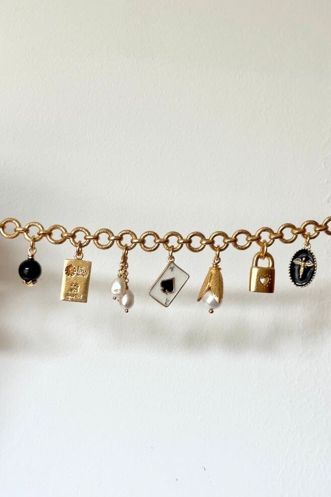 Ten beautiful, eye-catching charms dangle from an elegant gold plated 925 Sterling Silver chain bracelet.