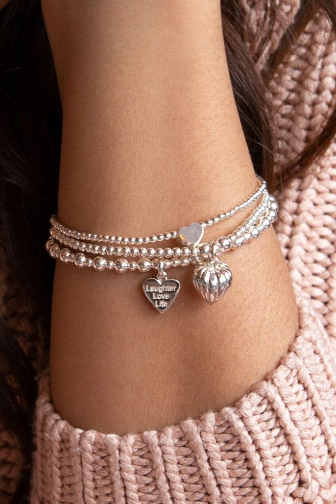 Three strand bracelet stack featuring 925 Sterling Silver heart charms and a personalised engraved motto charm.