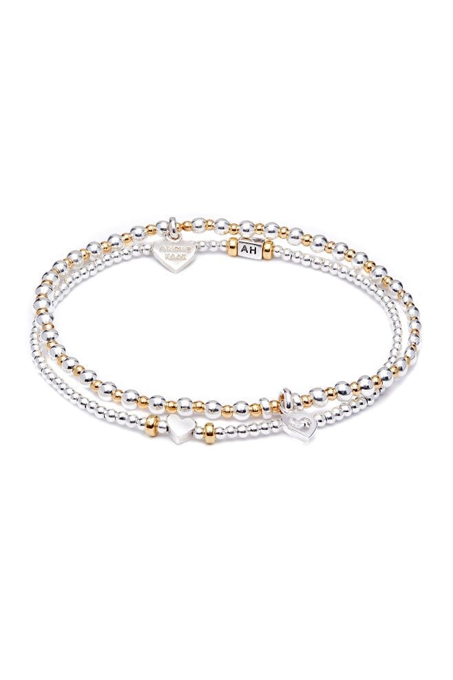 Handcrafted in 925 Sterling Silver, this two-strand stack is detailed with heart charms.