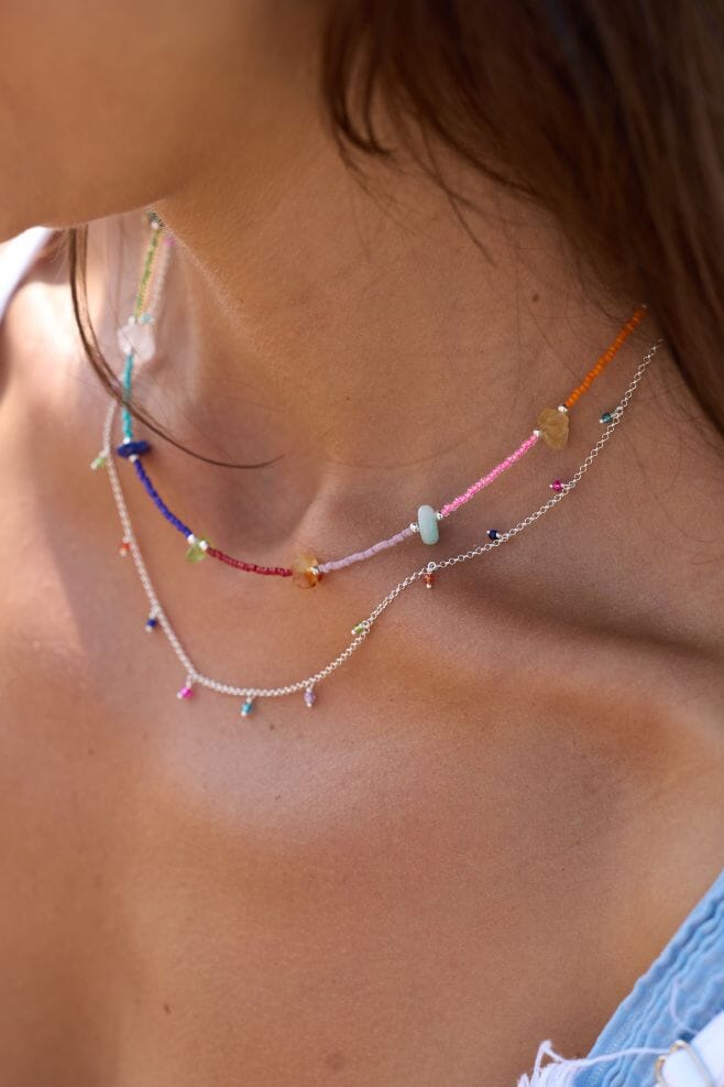 A delicate 925 Sterling Silver necklace decorated with vibrant colourful gemstones.