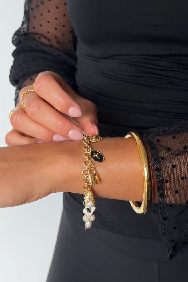 Ten beautiful, eye-catching charms dangle from an elegant gold plated 925 Sterling Silver chain bracelet.