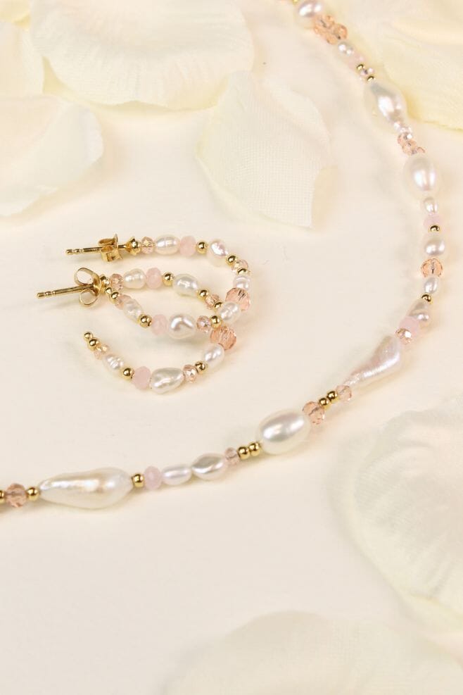 Unique hoop earrings featuring 18k gold plated Silver, Freshwater pearls, and sparkling pink crystals.