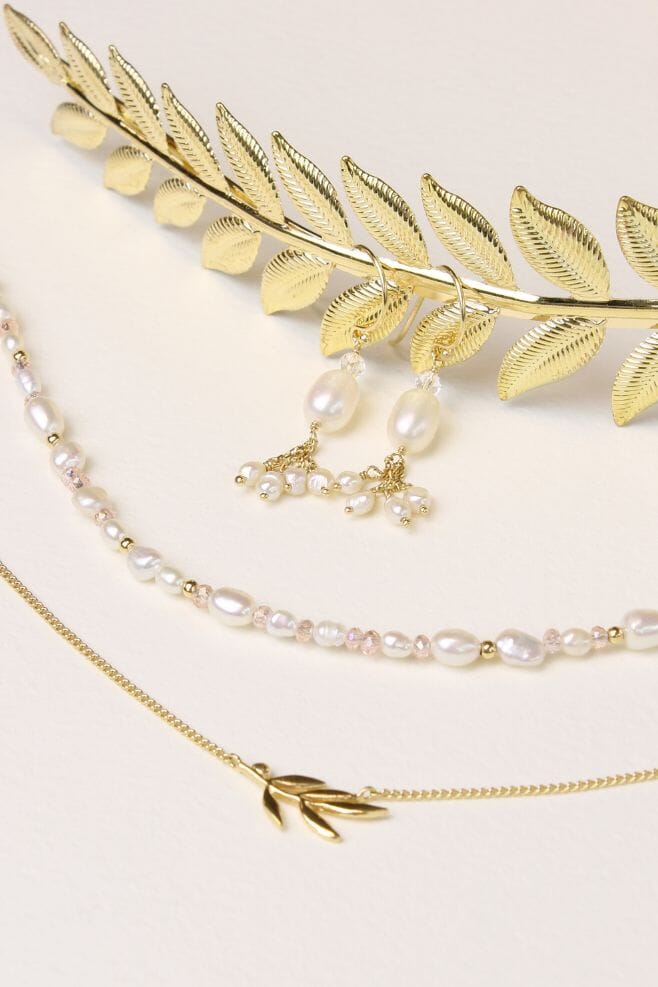 Elegant dangle earrings featuring 18k gold plated Silver, Freshwater pearls and sparkling pink crystal details.