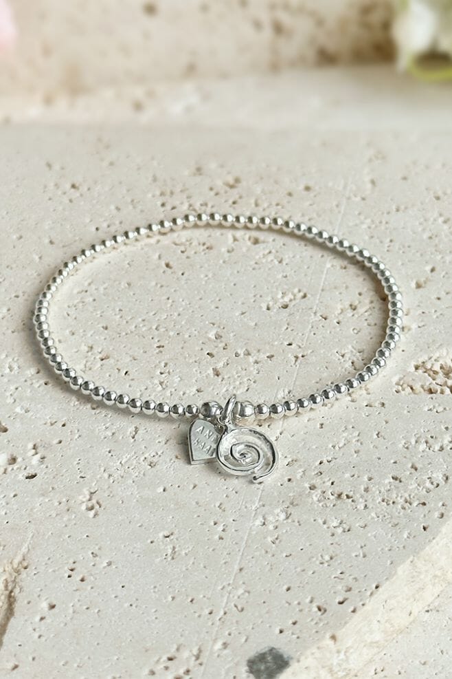 A classic Annie Haak Santeenie crafted in 925 Sterling Silver featuring a spiral charm.