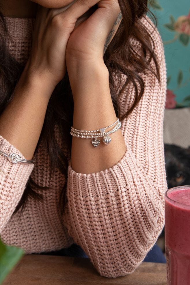 Three strand 925 Sterling Silver bracelet stack featuring heart shaped charms and a special charm engraved with your choice of motto!