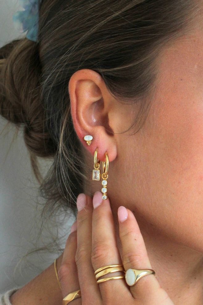 This classy Gold plated Silver earrings feature a stunning trio of crystals hanging from a hoop.