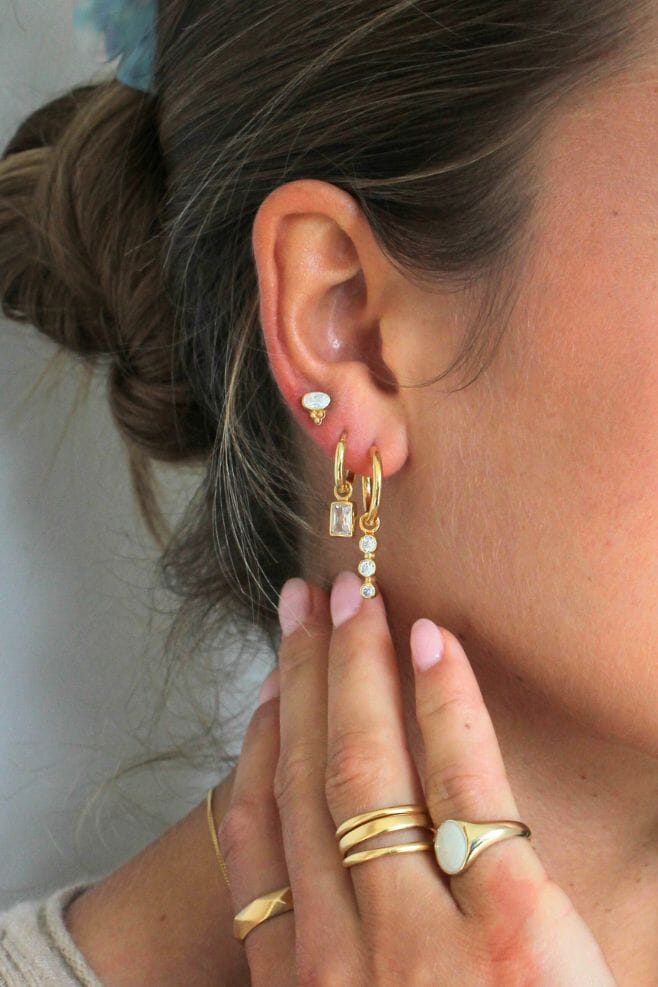 This classy Gold plated Silver earrings feature a stunning trio of crystals hanging from a hoop.