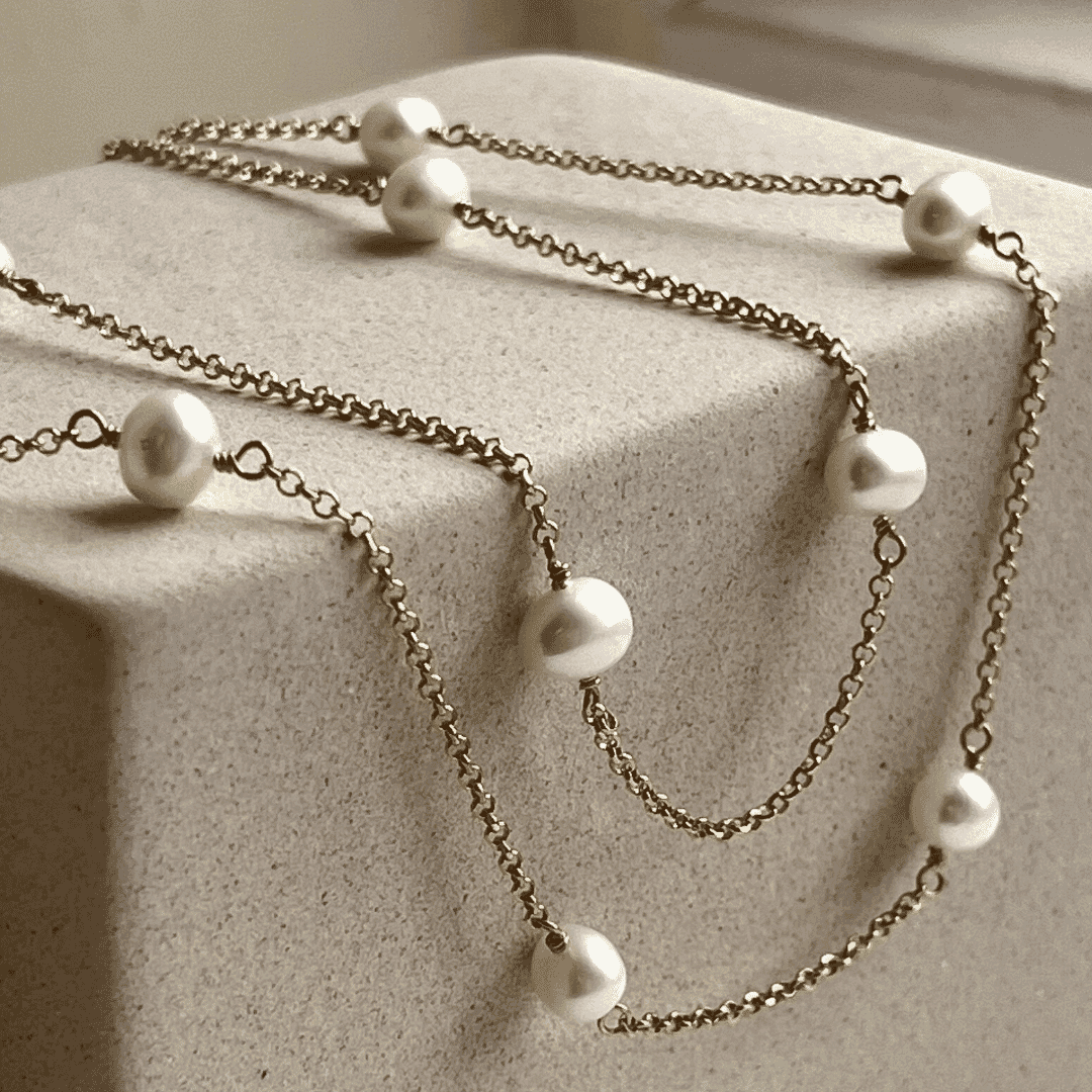 The necklace is a duo chain, handcrafted featuring stunning Freshwater Pearls.