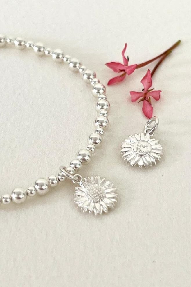 A new take on our classic Mini Orchid design, this stunning 925 Sterling Silver stackable bracelet has a new Sunflower charm.