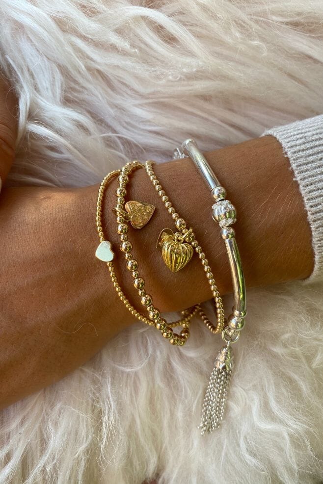 Three strand Gold plated Silver Bracelet Stack featuring three unique heart charm designs.