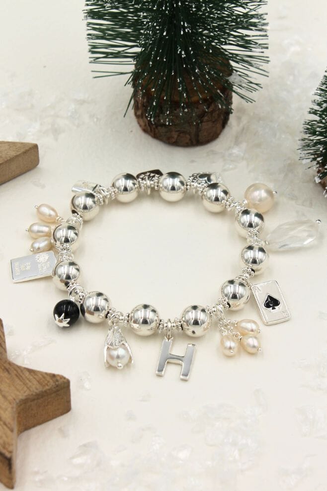 Ten beautiful, eye-catching charms dangle from a chunky 925 Sterling Silver bracelet with 10mm beads.