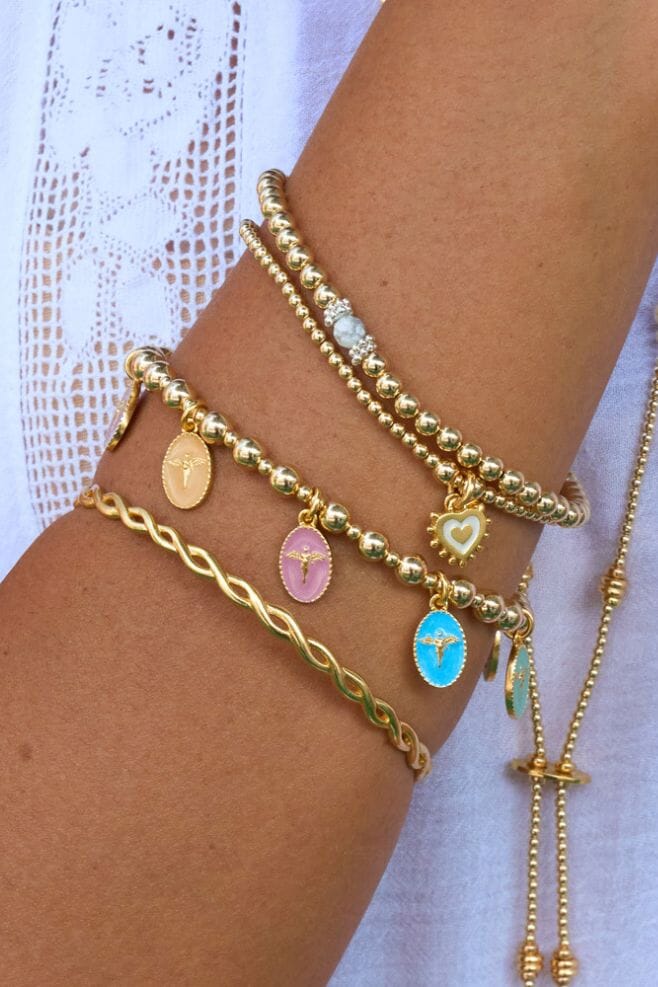 Handcrafted to perfection, the Serenity stack features four bracelets that each holds a unique charm and meaning.