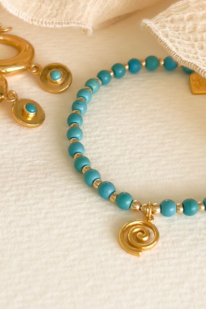 A Gold-Plated silver and turquoise bracelet featuring the ancient Spiral charm.