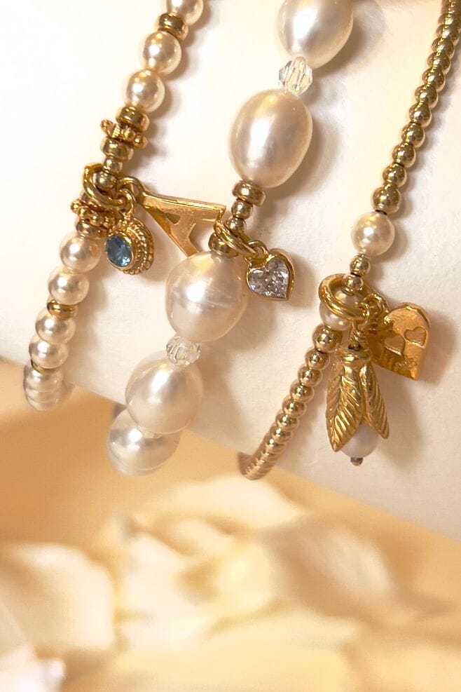 This elegant and personalised three-strand bracelet stack features 18k gold plated silver and a mix of Preciosa and Freshwater pearls.