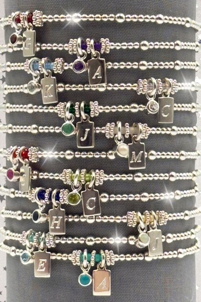 A stackable 925 Sterling Silver bracelet featuring semi-precious birthstone charm and an engraved initial.
