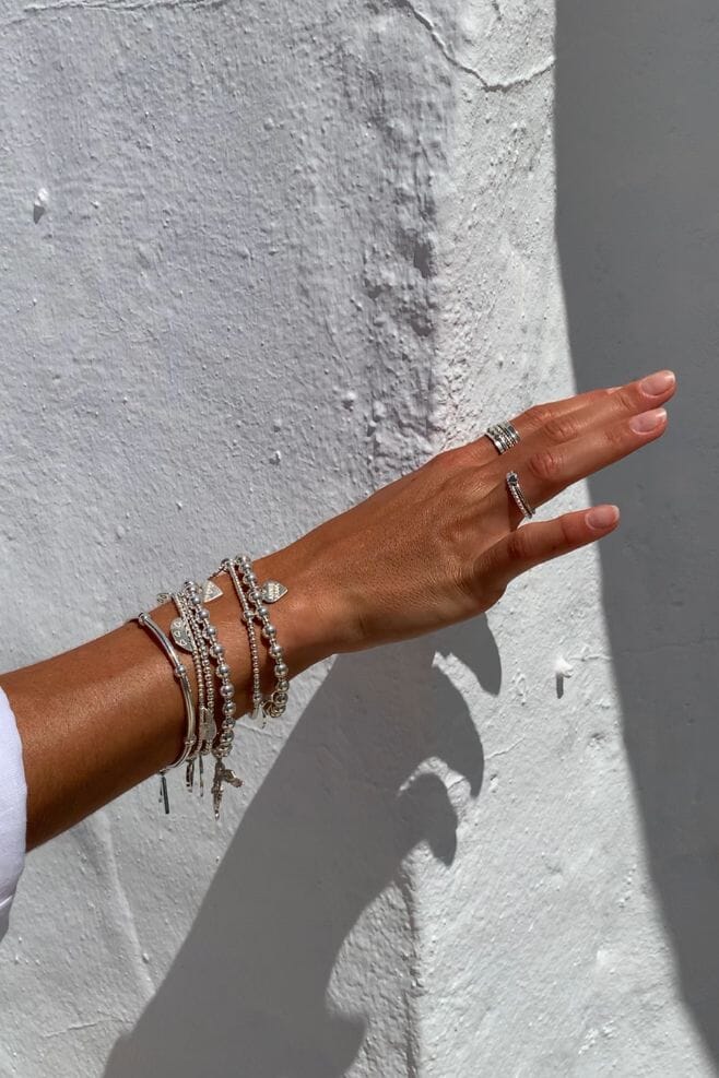 Five strand 925 Sterling Silver bracelet stack featuring our iconic Angel charm and a special charm engraved with your choice of  motto!