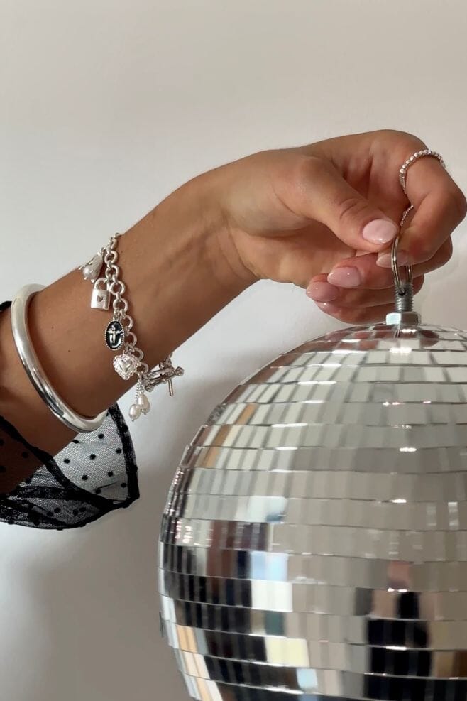 Ten beautiful, eye-catching charms dangle from this elegant 925 Sterling Silver chain bracelet, featuring pearls and Italian enamel.