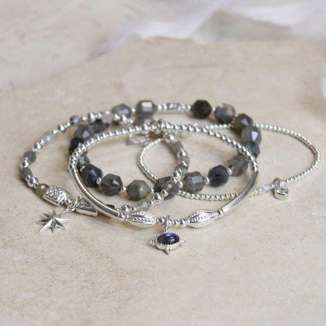 A four-strand bracelet stack, featuring 925 Sterling Silver and Labradorite.