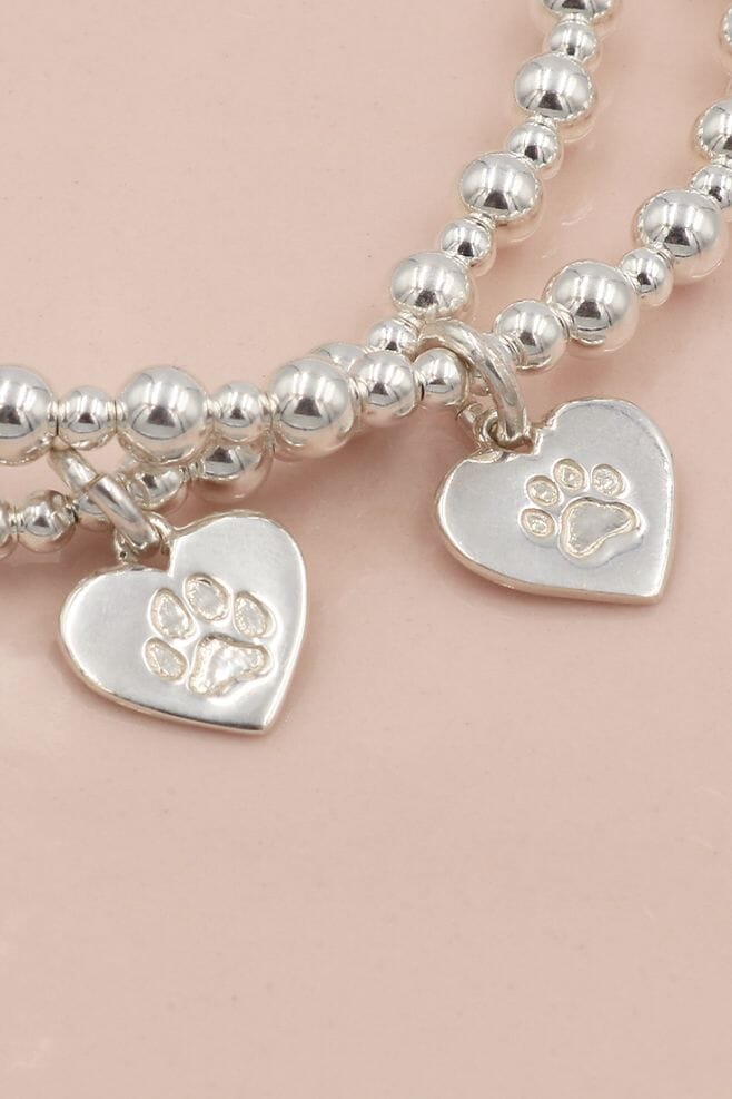 A sweet 925 Sterling Silver paw print stacking bracelet - featuring a personalised engraving on the reverse.