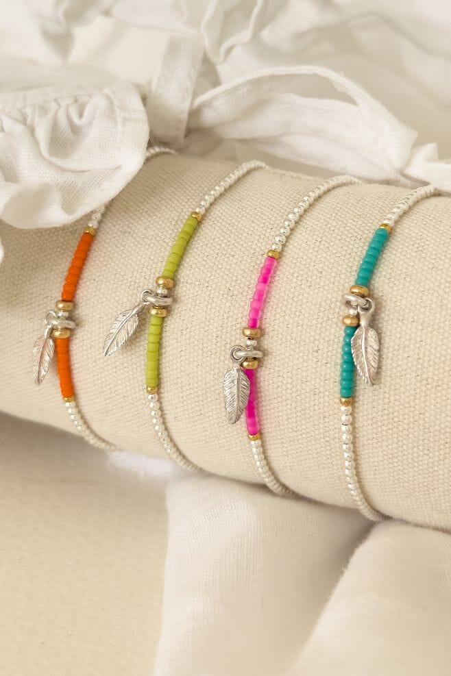 A stacking bracelet made with 925 Sterling Silver, gold-plated Silver, Japanese seed beads and a Feather charm - available in four colours.