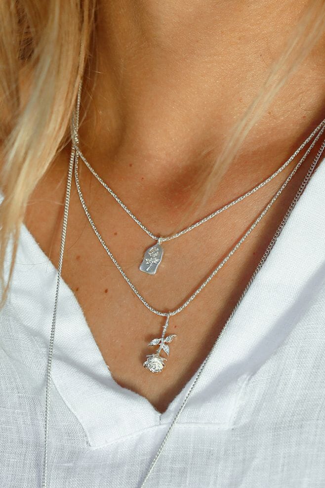 This contemporary necklace features an engraved Rose on a solid Sterling Silver Pendant. The perfect gift for a loved one.