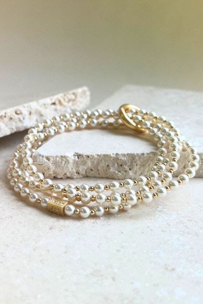 Looped bracelet featuring a continuous unbroken yard of Preciosa Pearls and dainty gold plated silver beads.