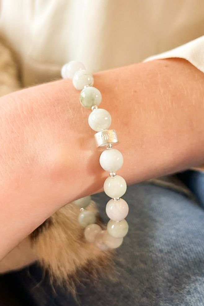 A hand-threaded bracelet featuring genuine Burma Jade gemstone and 925 Sterling Silver beads.