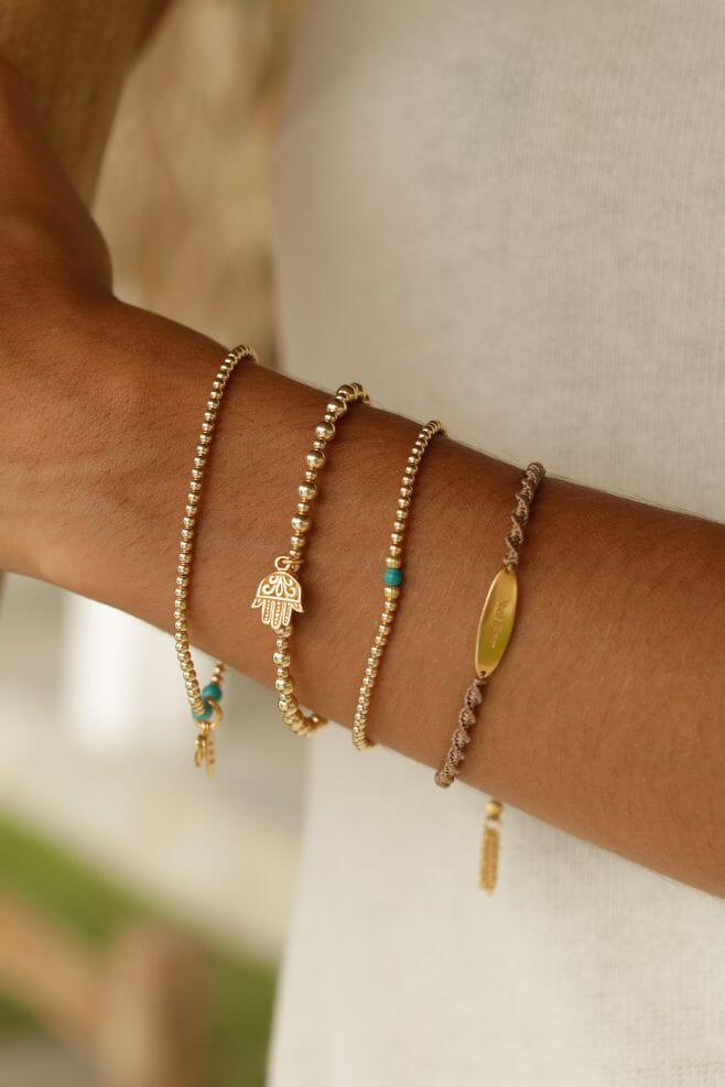 This stunning Gold Plated silver bracelet features a new ‘Fatima Hand’ charm amongst hand-threaded gold-plated Silver beads.