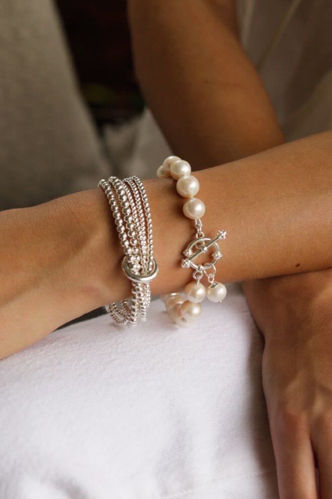 A 925 Sterling Silver wrap style bracelet featuring an unbroken yard of graduated beads held together with an iconic binding ring and finished off with an engraved Yard of Love bead.
