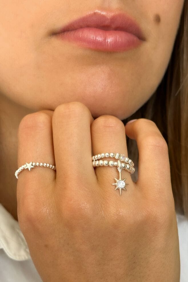 Combining two of our newest ring designs, the Aster Crystal Silver Ring and Mini Charm Astra Star Silver Ring, this dazzling combo is perfect for wearing separately or as a stack. 