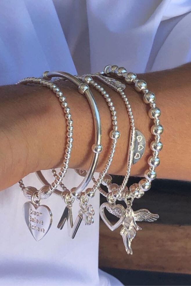 Our best-selling 5 strand bracelet stack featuring an initial and motto of your choice.