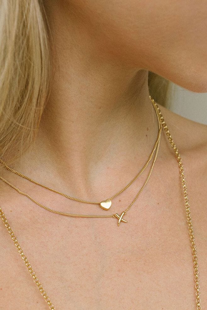 Handcrafted Gold plated Sterling Silver necklace featuring a 'Kiss' charm.