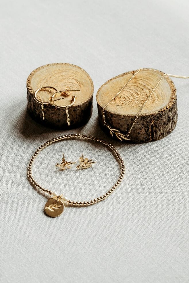 A unique design crafted in gold-plated silver and Preciosa pearls featuring an Olive Leaf motif and optional engraving.