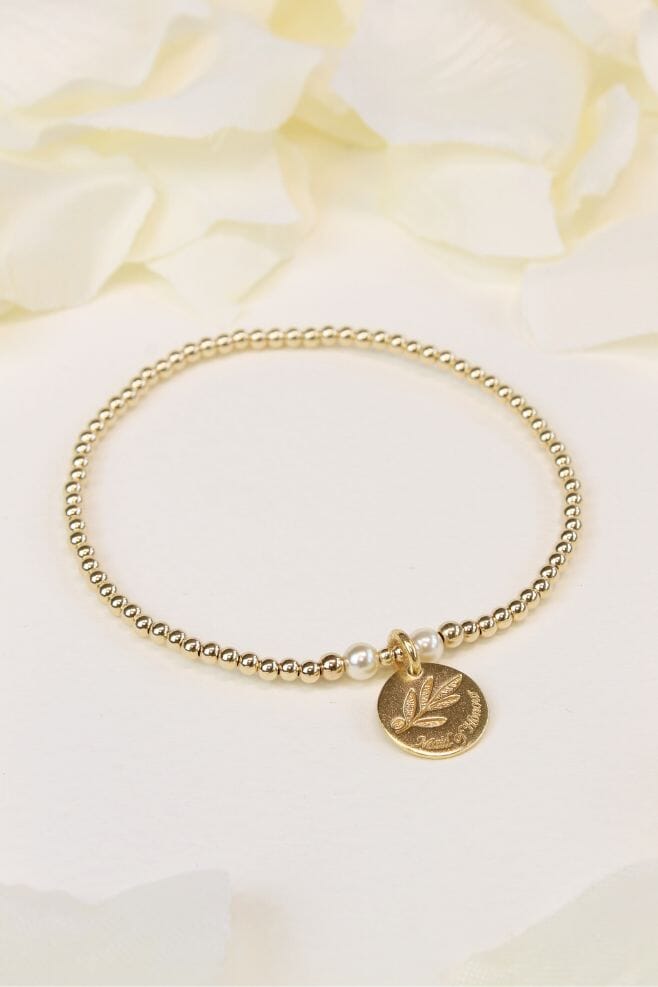 The perfect gift crafted in gold-plated silver and Preciosa pearls featuring an Olive Leaf motif on a Maid of Honour motto charm and optional engraving.