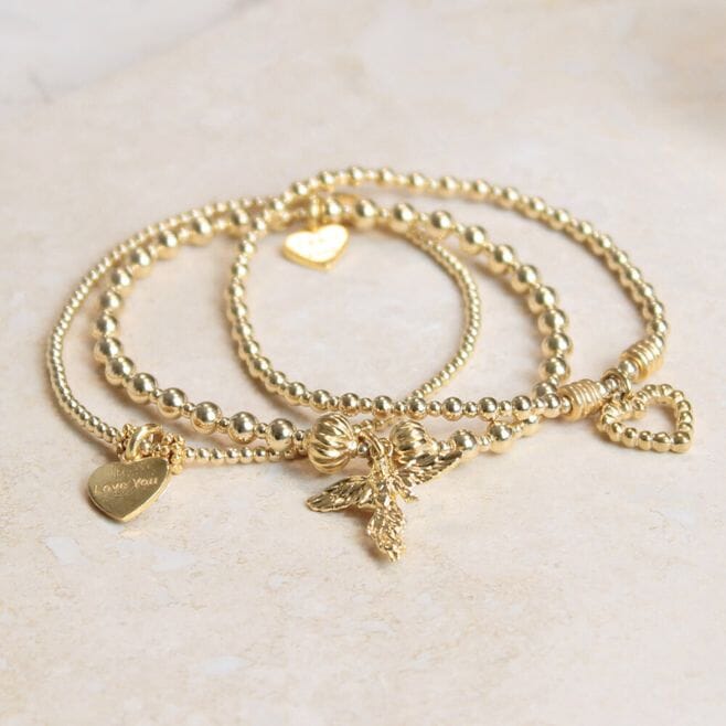 A three-strand bracelet stack, featuring 18 ct gold plated 925 Sterling Silver and meaningful charms.