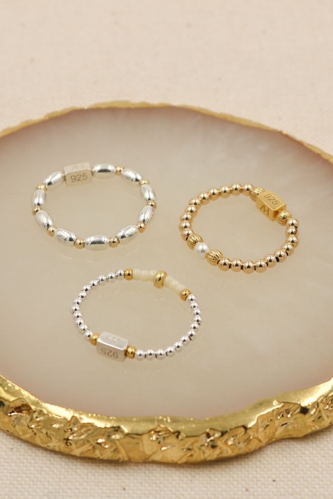 Discover mixed metal ring designs, hand-threaded on high-quality elastic for a perfect fit!