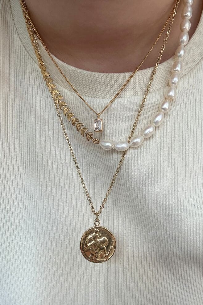 Our Flora Pearl Necklace is a sophisticated combination of a dainty contemporary leaf design chain in gold plated Silver and Freshwater Pearls.