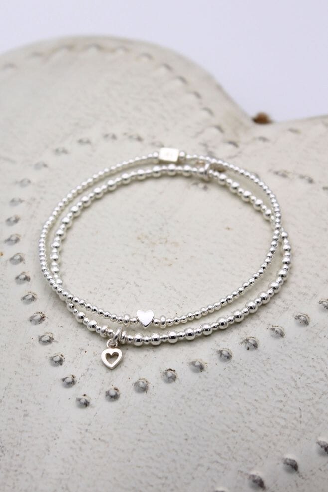 Handcrafted in 925 Sterling Silver, this two-strand stack is detailed with an Open Heart and a Teeny Boxed Heart.