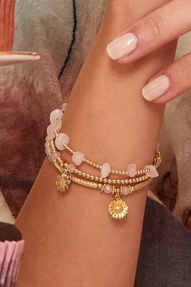 A three strand bracelet stack handcrafted in gold featuring Gold plated Sterling Silver and Rose Quartz.