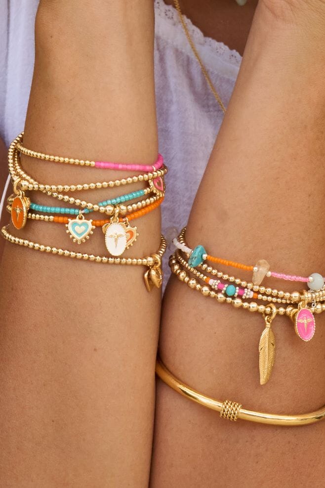 A gold-plated silver Santeenie bracelet with an Italian Enamel filled pink Silhouette Angel Charm.