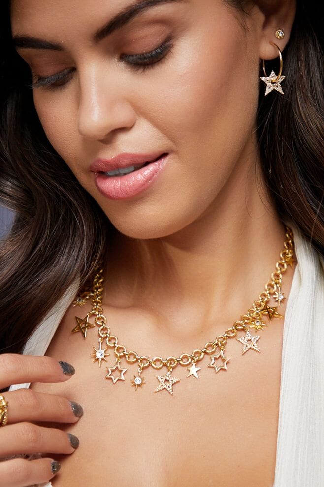 A chunky necklace featuring an array of beautifully designed gold-plated silver star charms.