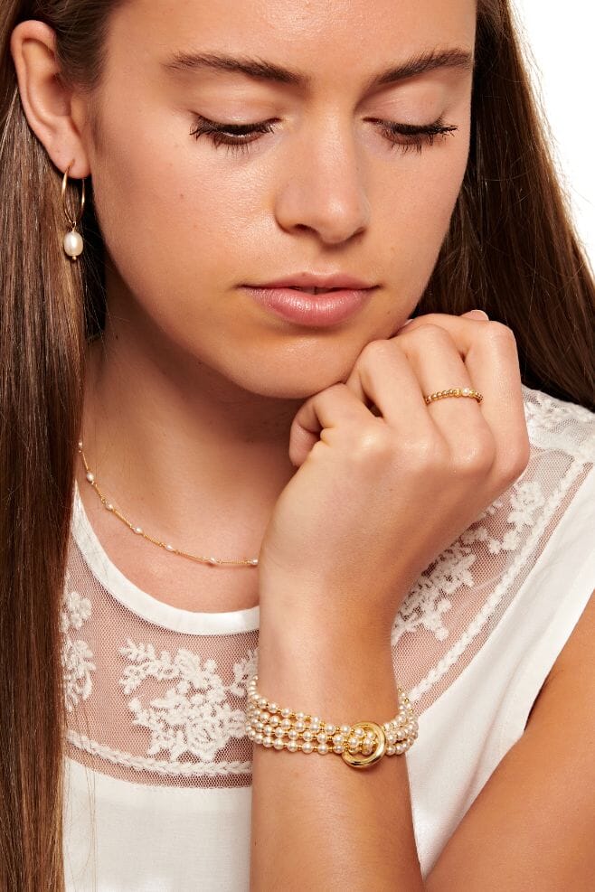 Looped bracelet featuring a continuous unbroken yard of Preciosa Pearls and dainty gold plated Silver beads.