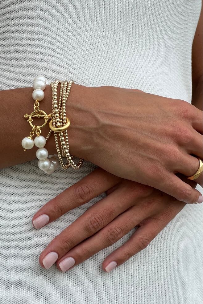 A statement bracelet featuring one long continuous yard of gold beads in a stunning wrap style bracelet.