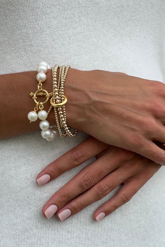 A gold plated 925 Sterling Silver wrap style bracelet featuring an unbroken yard of graduated beads held together with an iconic binding ring and finished off with an engraved Yard of Love bead.