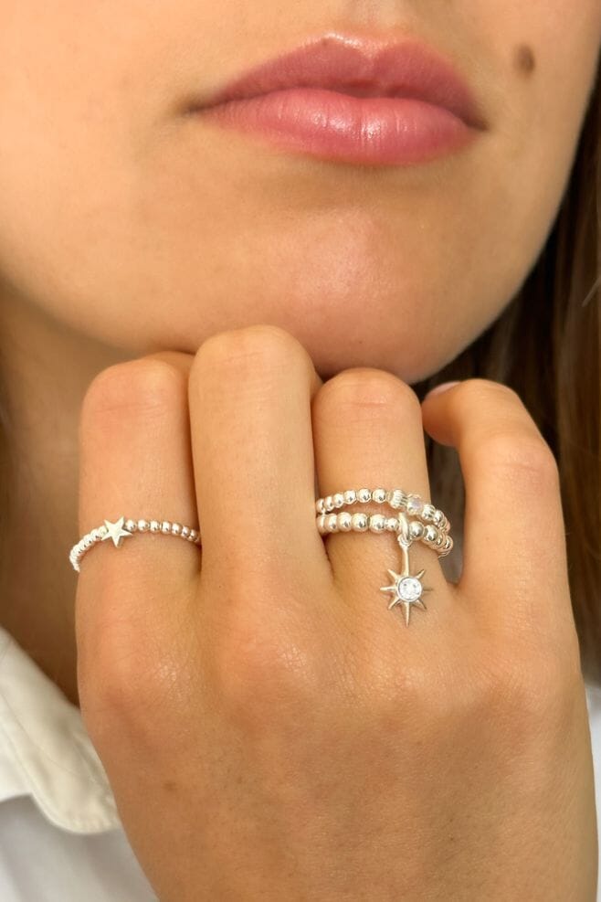 A beaded dainty ring featuring an elegant star shaped solid charm, amongst fine 925 Sterling Silver beads.