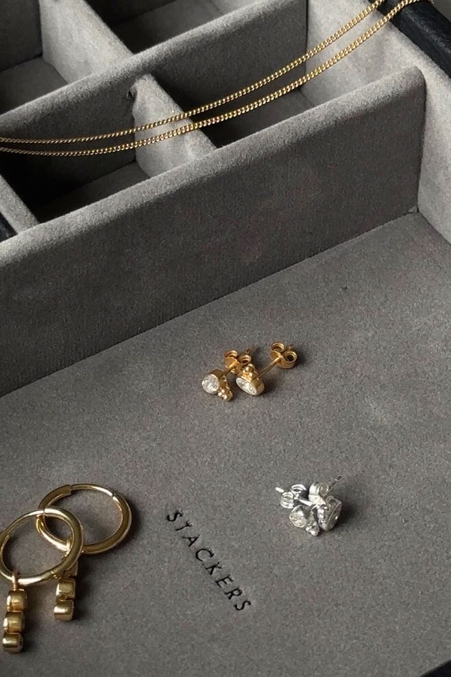 A charming pair of studs showcasing a Zirconia crystal centrepiece with a three-dot cluster detail.
