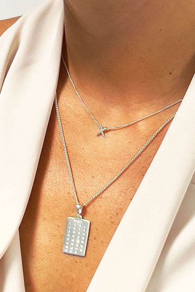 A calendar page pendant featuring the date of your choice and an engraving on the back.
