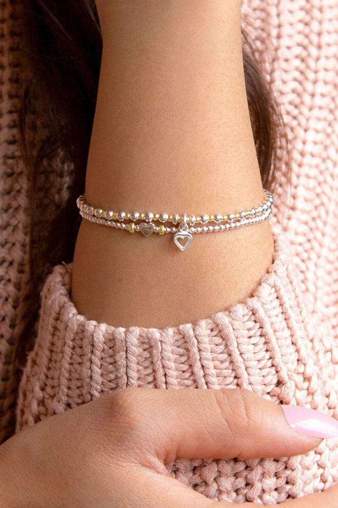Handcrafted in 925 Sterling Silver, this two-strand stack is detailed with an Open Heart and a Teeny Boxed Heart.