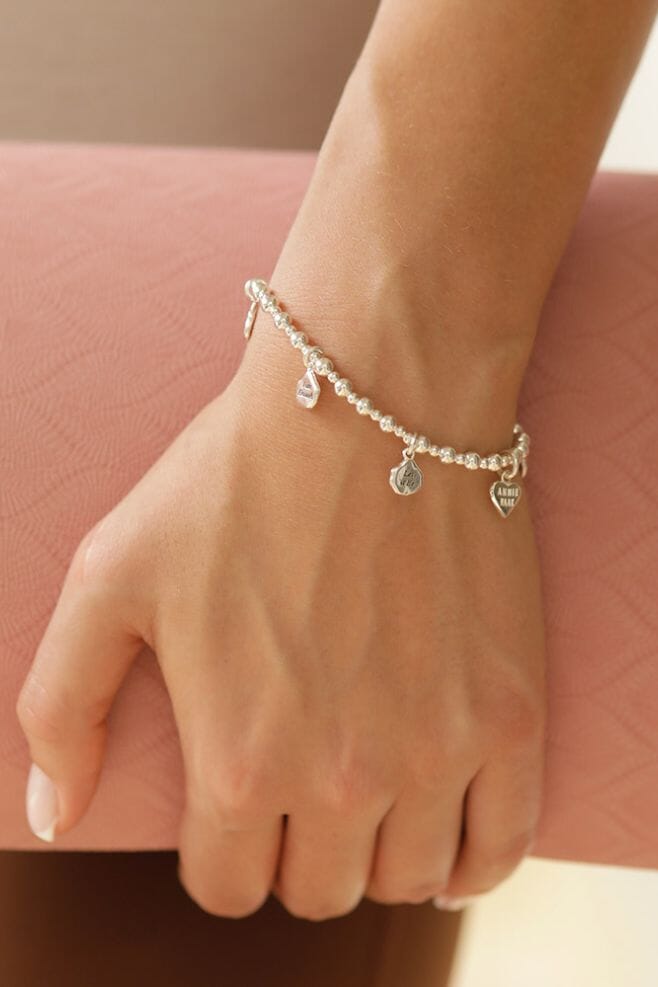 A stackable bracelet featuring six affirmation charms, placed between chunky beads of 925 Sterling Silver.